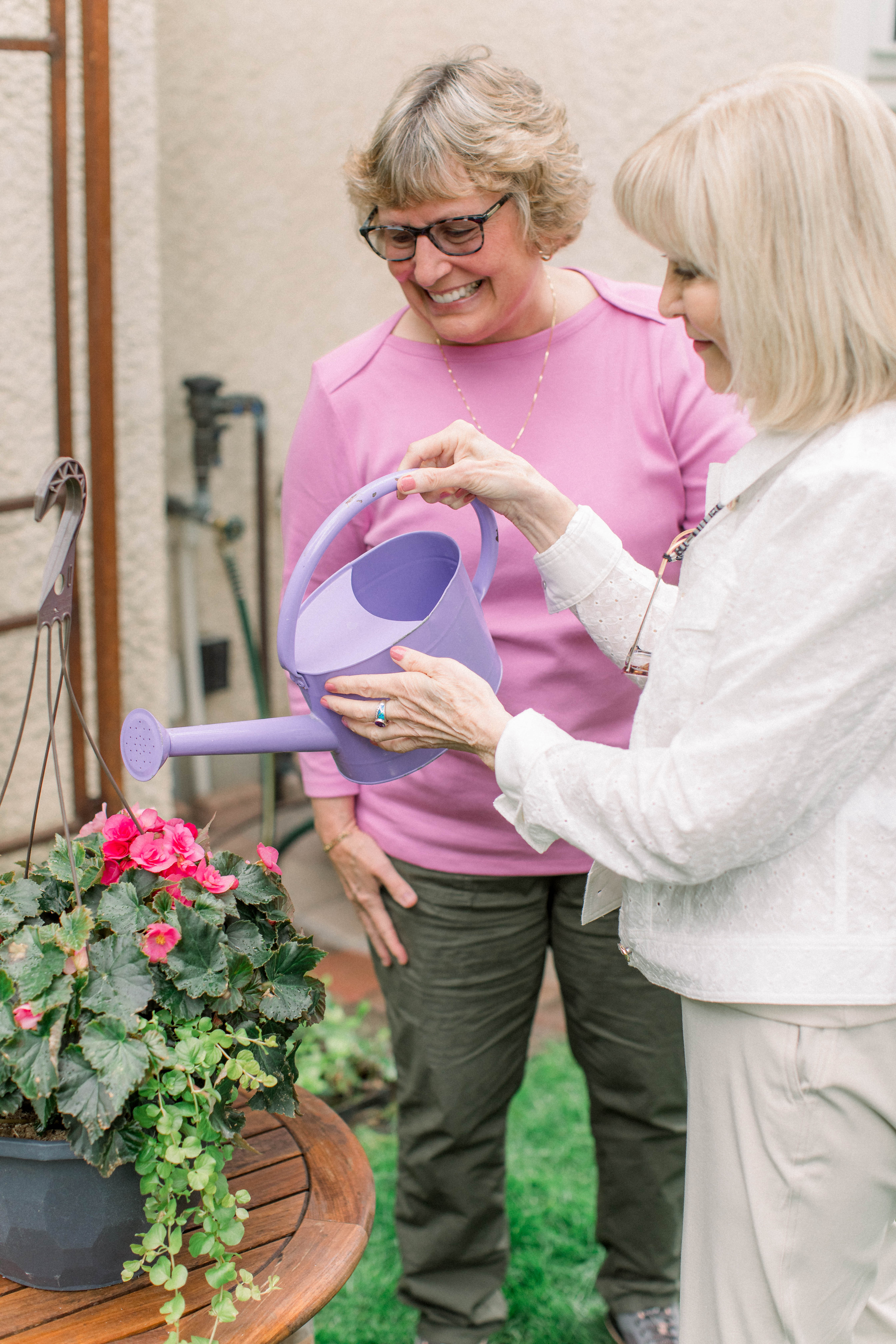 A Joyful Companions caregiver gardening alongside a client